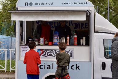 photo d'un food truck ouvert avec deux jeunes qui commandent
