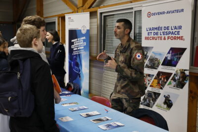photo de deux jeunes garçons qui échangent avec un homme militaire en costume - Agrandir l'image 4 sur 22, fenêtre modale