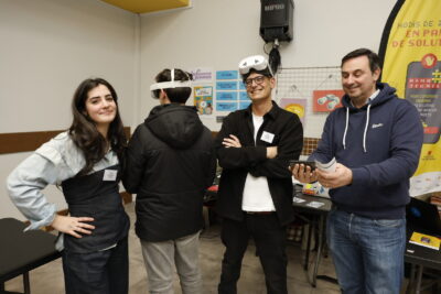 photo de quatre personnes, un jeune essaie des lunettes de réalité virtuelle,les autres sourient - Agrandir l'image 10 sur 22, fenêtre modale