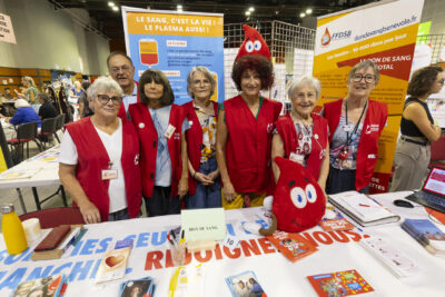 photo de six femmes et un homme avec un gilet rouge, plutôt âgés, qui sont debout derière un stand pour le don du sang - Agrandir l'image 16 sur 16, fenêtre modale