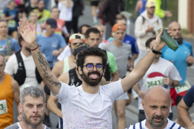 photo de la course, le focus est sur un homme qui a les bras en l'air et tire la langue en regardant l'objectif - Agrandir l'image 3 sur 19, fenêtre modale