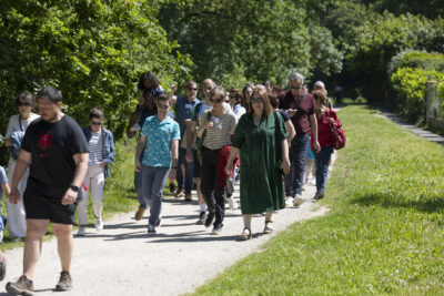 Groupes de personnes de tout âge en balade sur un chemin piétonnier dans un espace vert - Agrandir l'image 10 sur 16, fenêtre modale