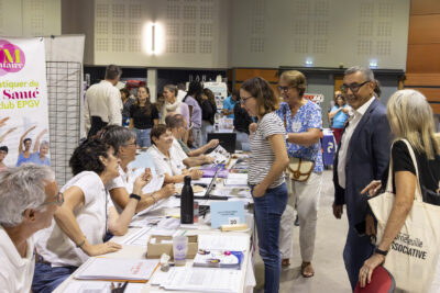 photo de l'intérieur du Phare, on voit depuis le côté de plusieurs stands, le Maire et une élue échangent avec les personnes qui tiennent le stand - Agrandir l'image 15 sur 68, fenêtre modale