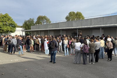 Photo des élèves et familles rassemblées dans la cour, tous tournés dans la même direction - Agrandir l'image 16 sur 80, fenêtre modale