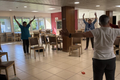 photo d'une activité gym à la résidence autonome, on voit quelques personnes âgées en train de faire des exercices en cercle - Agrandir l'image 2 sur 3, fenêtre modale